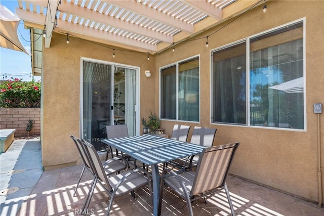 view of patio / terrace with fence, a pergola, and outdoor dining space