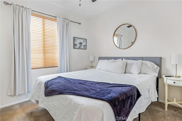 carpeted bedroom with a ceiling fan and baseboards