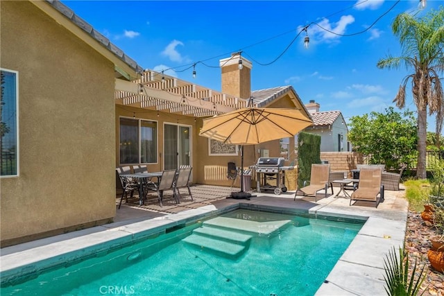 view of pool featuring a fenced in pool, area for grilling, outdoor dining area, a patio area, and a pergola