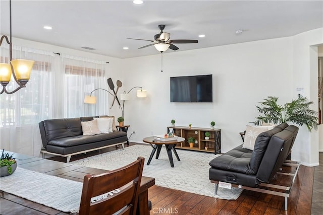 living room featuring visible vents, dark wood-type flooring, and recessed lighting