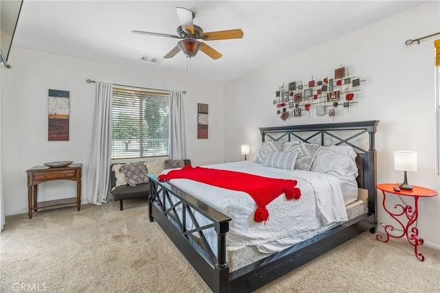 carpeted bedroom featuring visible vents and a ceiling fan