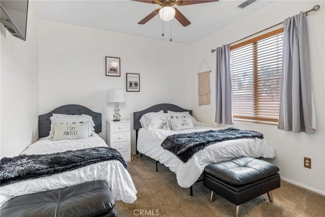 carpeted bedroom featuring ceiling fan, visible vents, and baseboards