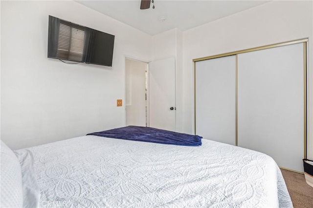 carpeted bedroom with a closet and ceiling fan