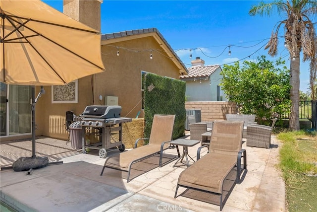 view of patio / terrace featuring fence and grilling area