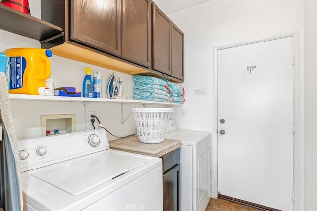 washroom featuring cabinet space and separate washer and dryer