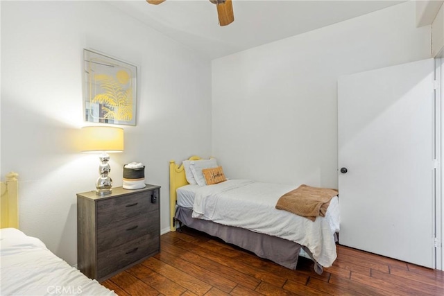 bedroom with a ceiling fan and dark wood-style flooring