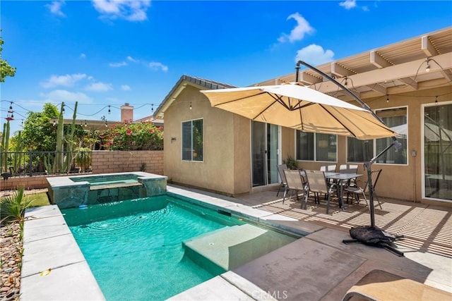 view of swimming pool with a patio area, a pool with connected hot tub, and fence