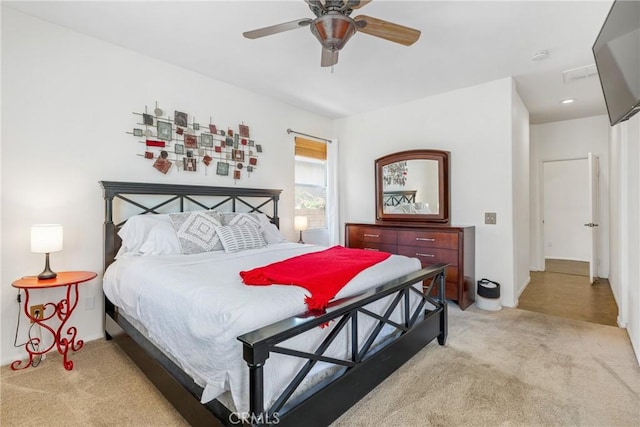 bedroom featuring a ceiling fan and light colored carpet