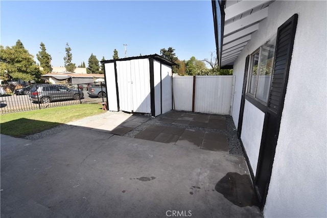 exterior space featuring fence private yard, a shed, and an outdoor structure