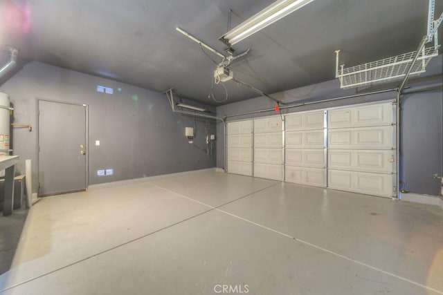 garage with strapped water heater and a garage door opener