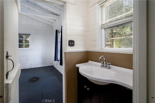 bathroom with lofted ceiling and vanity