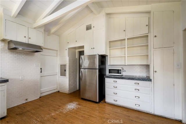 kitchen with dark countertops, light wood finished floors, white cabinetry, and freestanding refrigerator