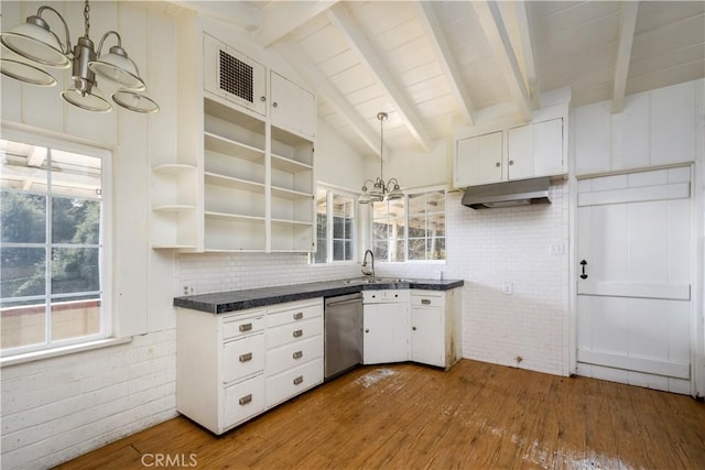 kitchen featuring hanging light fixtures, stainless steel dishwasher, white cabinetry, open shelves, and a notable chandelier