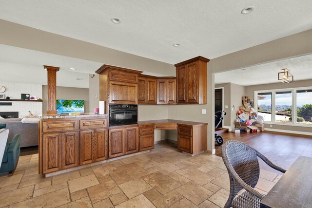 29345 Wilkes Rd, Valley Center, CA 92082 - kitchen featuring open floor plan, black oven, light countertops, brown cabinets, and recessed lighting