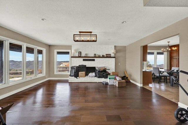 29345 Wilkes Rd, Valley Center, CA 92082 - living area featuring a chandelier, healthy amount of natural light, wood finished floors, and a textured ceiling