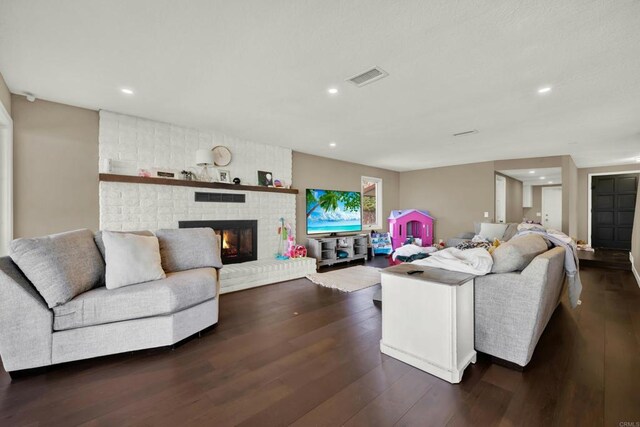 29345 Wilkes Rd, Valley Center, CA 92082 - living room featuring dark wood-type flooring, a brick fireplace, and recessed lighting