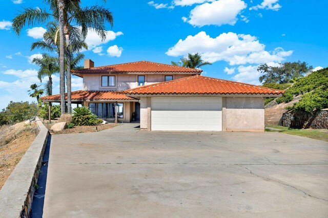 29345 Wilkes Rd, Valley Center, CA 92082 - mediterranean / spanish house with stucco siding, an attached garage, and concrete driveway