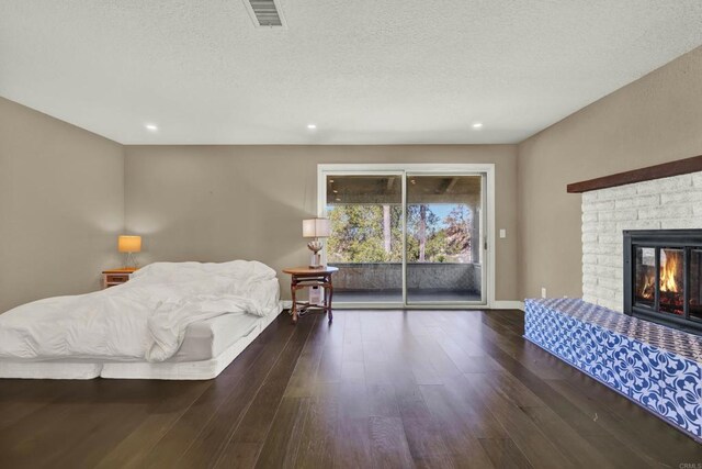 29345 Wilkes Rd, Valley Center, CA 92082 - living area featuring wood finished floors, a brick fireplace, a textured ceiling, and recessed lighting