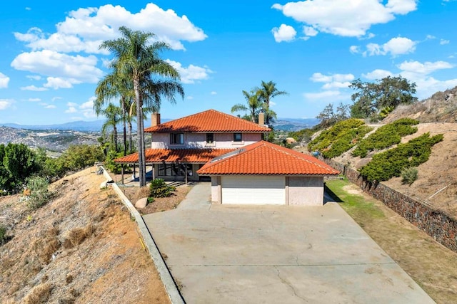 29345 Wilkes Rd, Valley Center, CA 92082 - mediterranean / spanish-style home with a tile roof, a chimney, a mountain view, stucco siding, and a detached garage