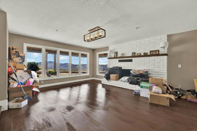 29345 Wilkes Rd, Valley Center, CA 92082 - living room featuring a textured ceiling, wood finished floors, a mountain view, and a chandelier