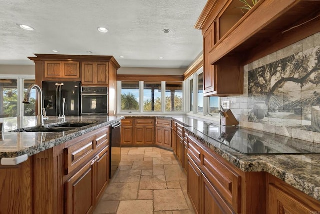 29345 Wilkes Rd, Valley Center, CA 92082 - kitchen featuring black appliances, stone tile flooring, brown cabinetry, tasteful backsplash, and recessed lighting