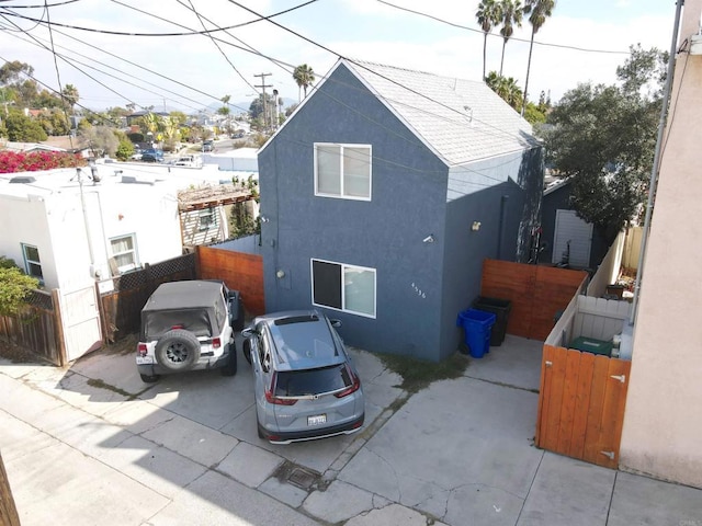 exterior space featuring fence and stucco siding