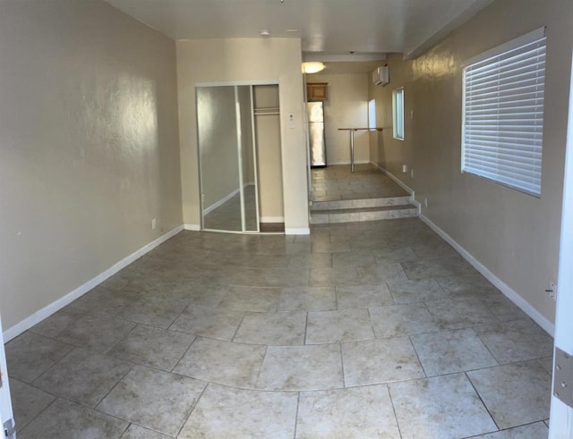 unfurnished room with baseboards