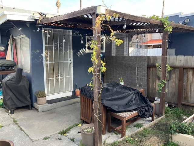 view of patio / terrace with fence and a pergola