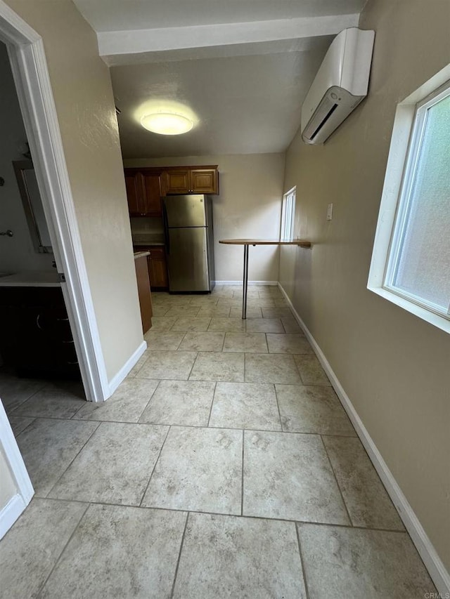 hallway with a wall mounted AC and baseboards