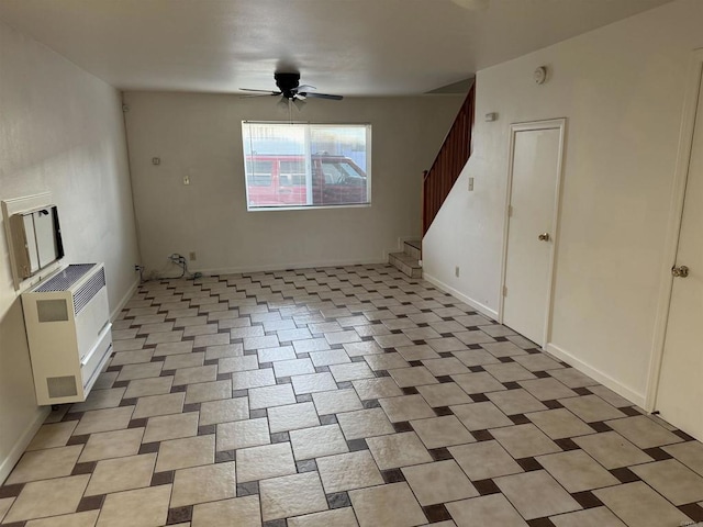 interior space with a ceiling fan, stairway, and baseboards