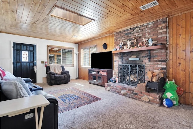 living room featuring carpet, a wealth of natural light, wooden ceiling, and visible vents