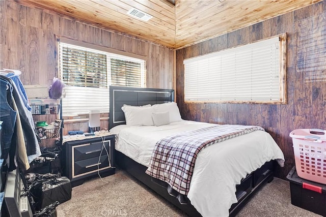 bedroom featuring visible vents, wood walls, carpet flooring, and wood ceiling