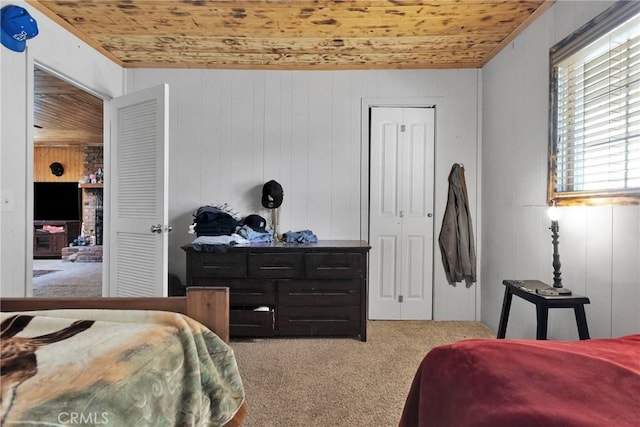 bedroom with carpet floors and wood ceiling