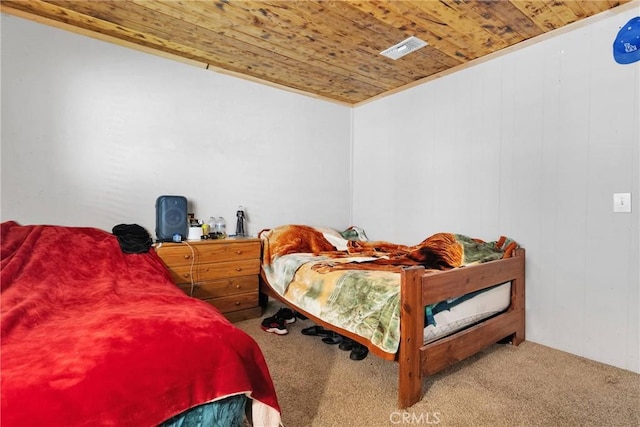 carpeted bedroom featuring wooden ceiling and visible vents