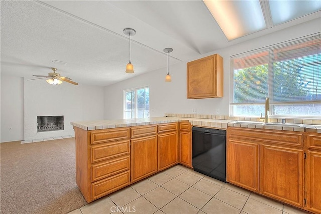 kitchen with light carpet, black dishwasher, decorative light fixtures, a peninsula, and a fireplace