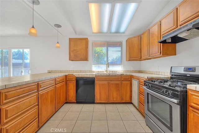 kitchen featuring black dishwasher, decorative light fixtures, stainless steel gas range, under cabinet range hood, and a sink