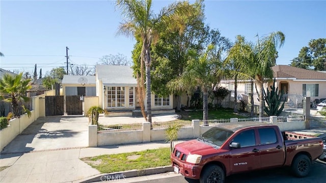 view of front of home with a fenced front yard and a gate