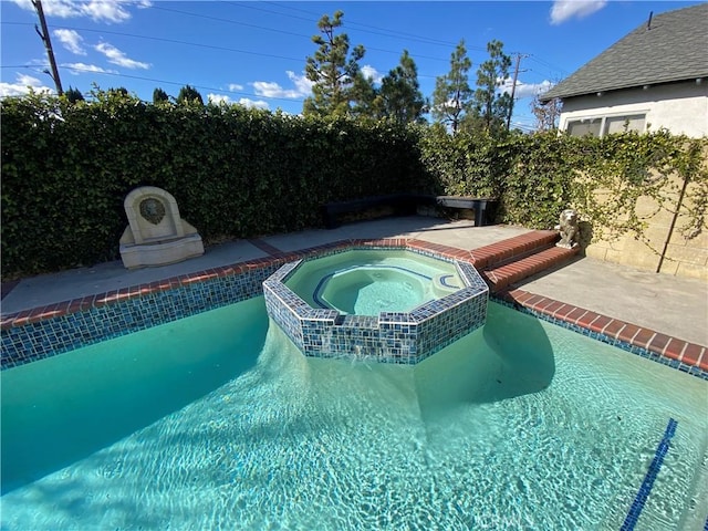 view of swimming pool with a pool with connected hot tub