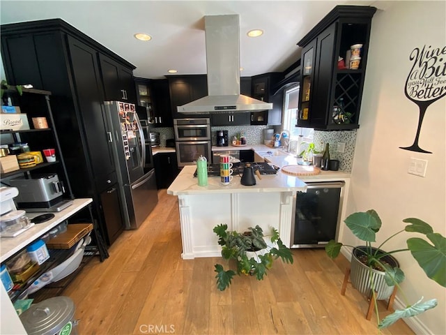 kitchen with dark cabinets, light countertops, glass insert cabinets, and island range hood