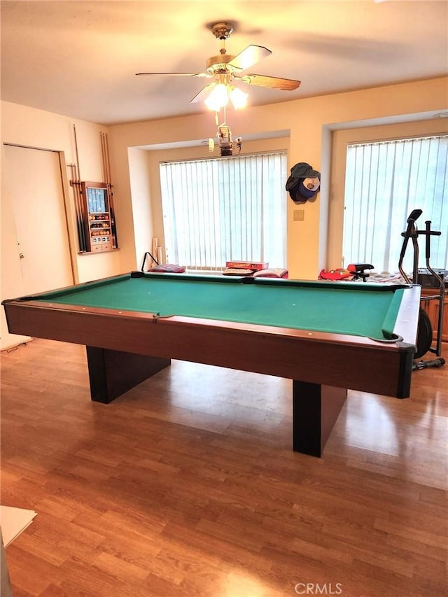 rec room featuring billiards, wood finished floors, a wealth of natural light, and a ceiling fan