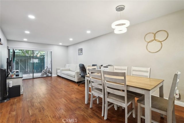 dining area featuring recessed lighting, baseboards, and wood finished floors