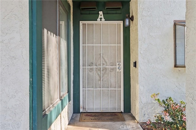 doorway to property with stucco siding