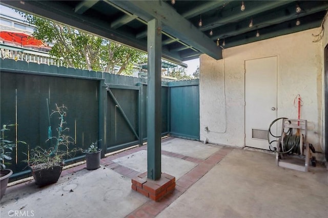 view of patio / terrace featuring fence and a gate