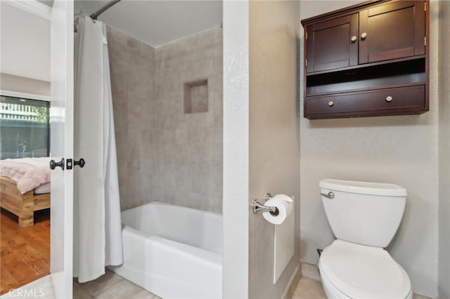 full bathroom with tile patterned floors, toilet, shower / tub combo with curtain, and connected bathroom