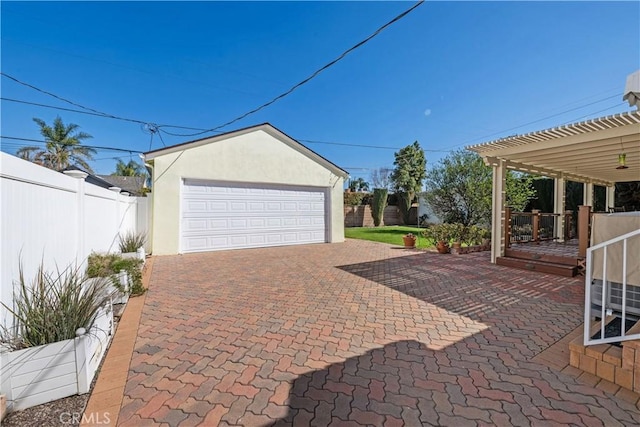 detached garage featuring fence