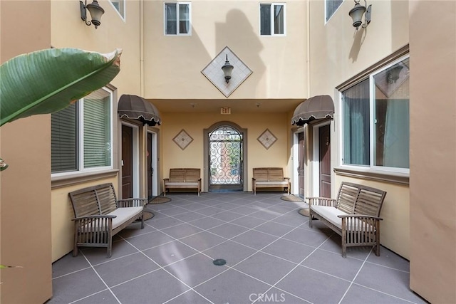 doorway to property with a patio and stucco siding