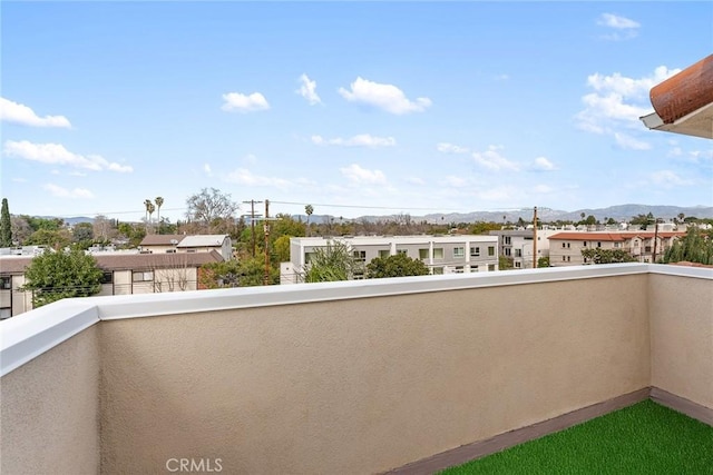 balcony featuring a mountain view and a residential view