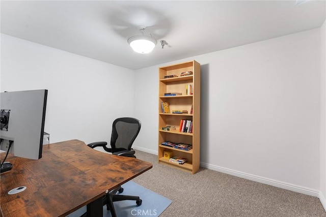 home office with baseboards and carpet flooring