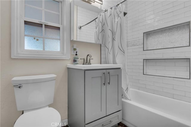 bathroom featuring toilet, shower / tub combo, and vanity