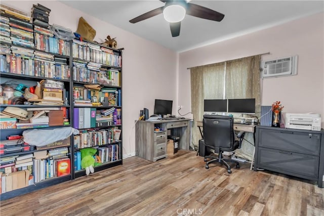 office space featuring ceiling fan, a wall mounted air conditioner, and wood finished floors